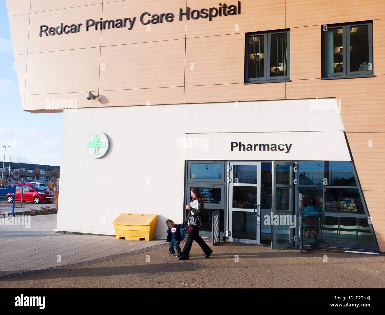 Redcar Primary Care Hospital entrance and Pharmacy mother  and child passing Stock Photo