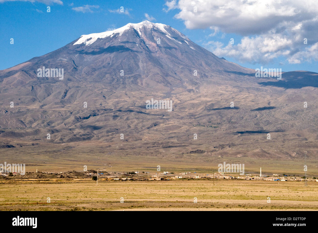 Mount Ararat, or Agri Dagi, a snowcapped dormant volcanic massif towers over a tiny village in eastern Anatolia, Turkey. Stock Photo