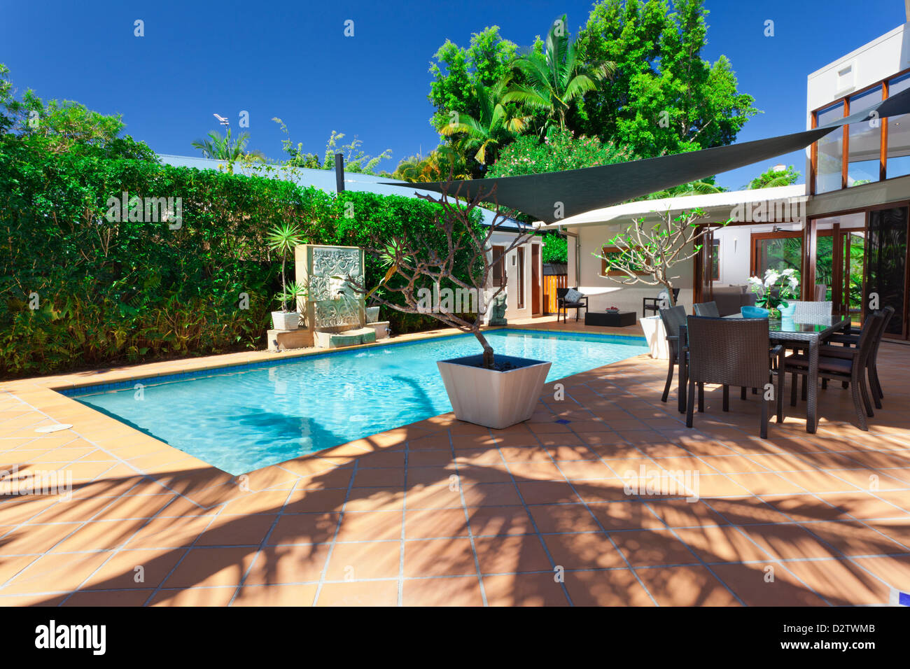Modern Backyard With Swimming Pool And Entertaining Area In Stock