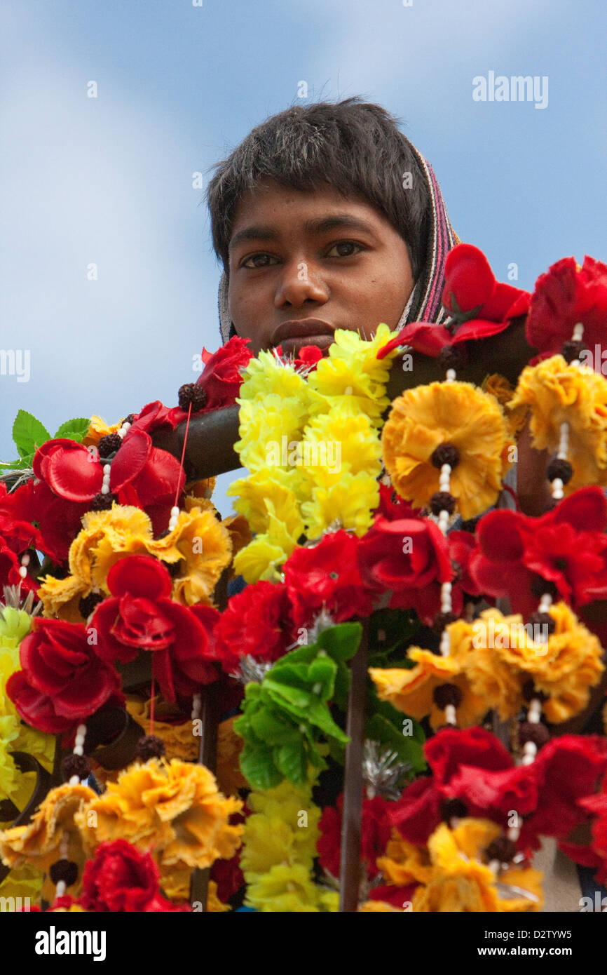 India, Rishikesh. Boy with Flowers for Sale as Offerings. Stock Photo