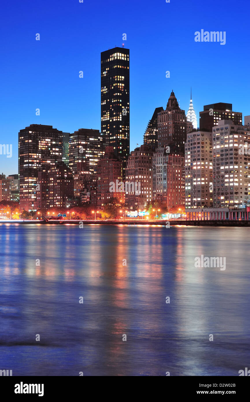 New York City Manhattan midtown skyline at night over East River Stock ...