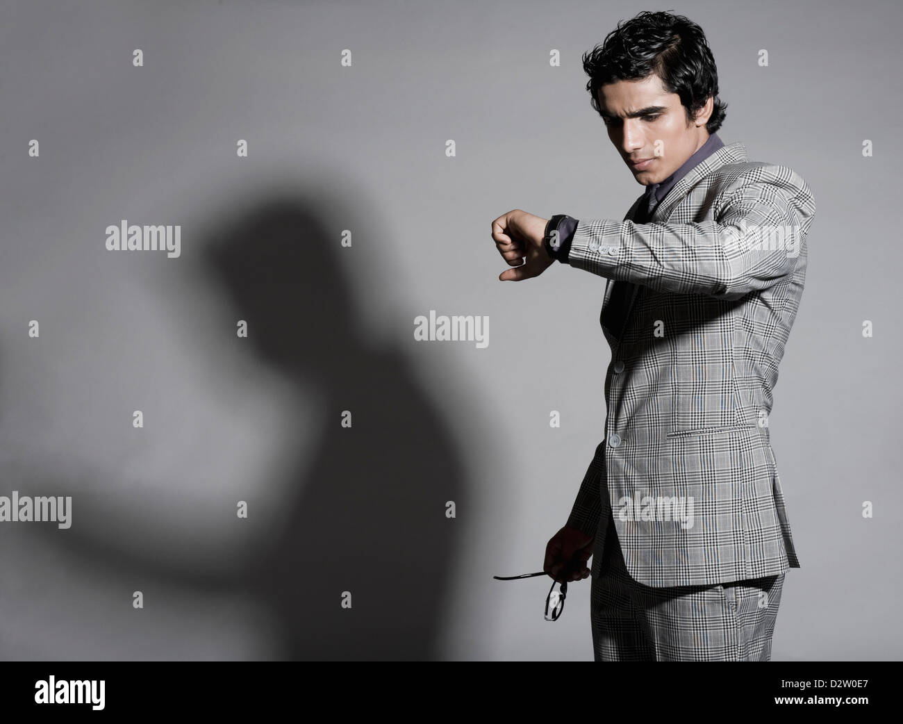 Businessman checking the time Stock Photo - Alamy