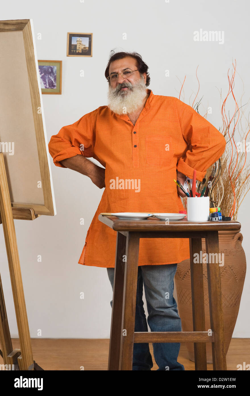 Painter standing with his arms akimbo Stock Photo - Alamy