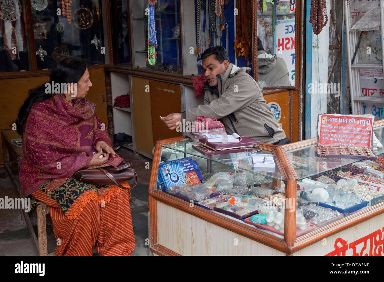 India, Rishikesh. Woman Discussing a Purchase in Jeweler's Shop. Stock Photo