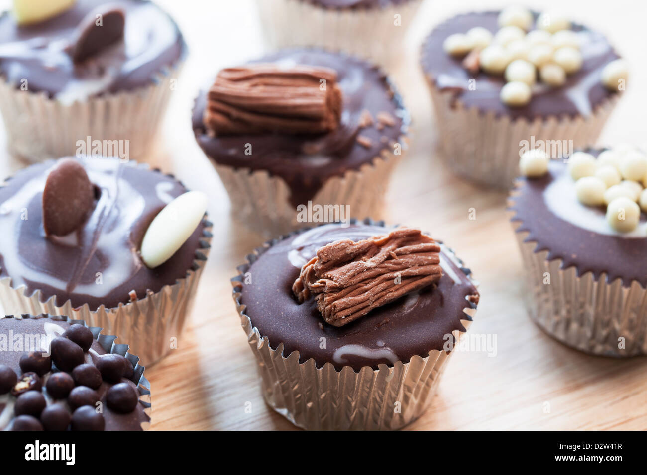 Gourmet chocolate cupcakes in silver cupcake wrappers Stock Photo