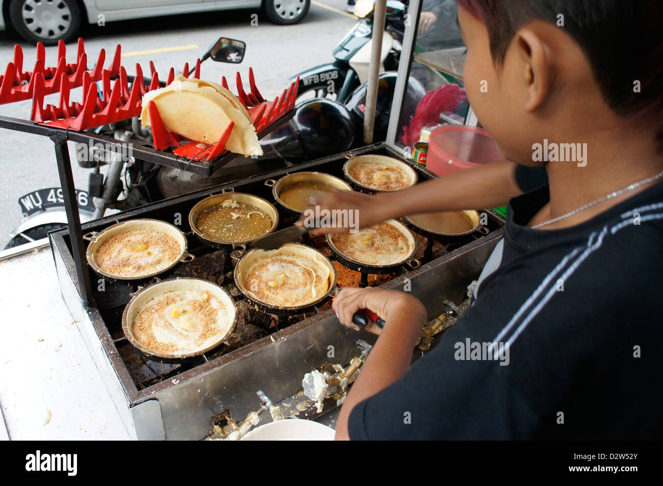 hawker making Apam balik (turnover pancake) Malaysian pancake with sugar, peanuts and creamy sweet corn fillings Stock Photo