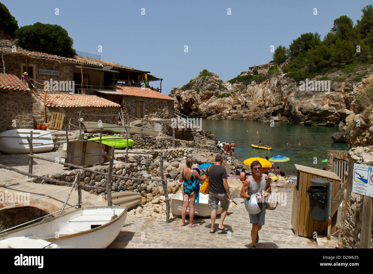 Rocky beach of Deya, Majorca. The fish restaurant to the left. Stock Photo