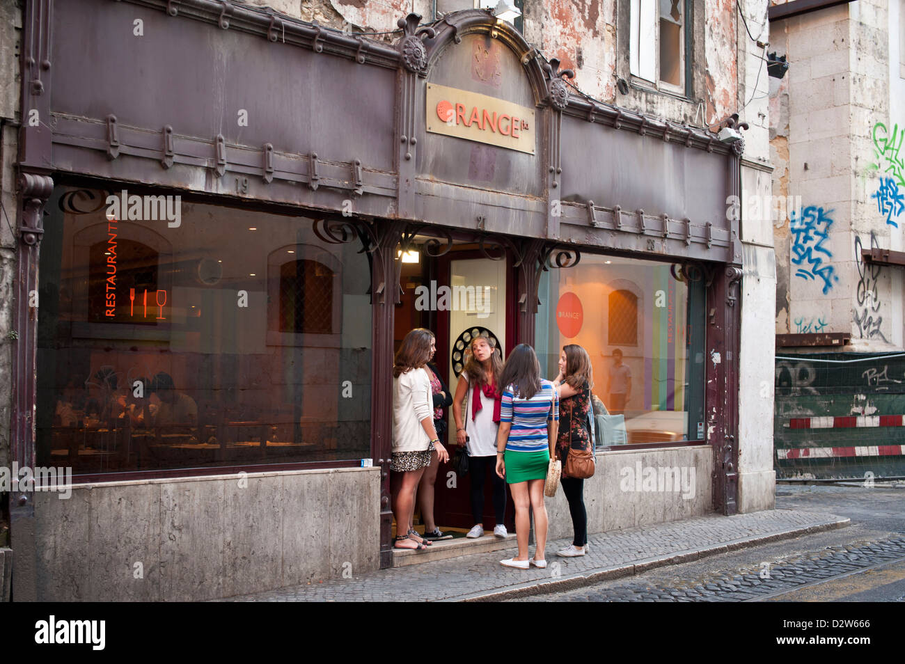 Young women discuss their options outside a restaurant, Lisbon Stock Photo