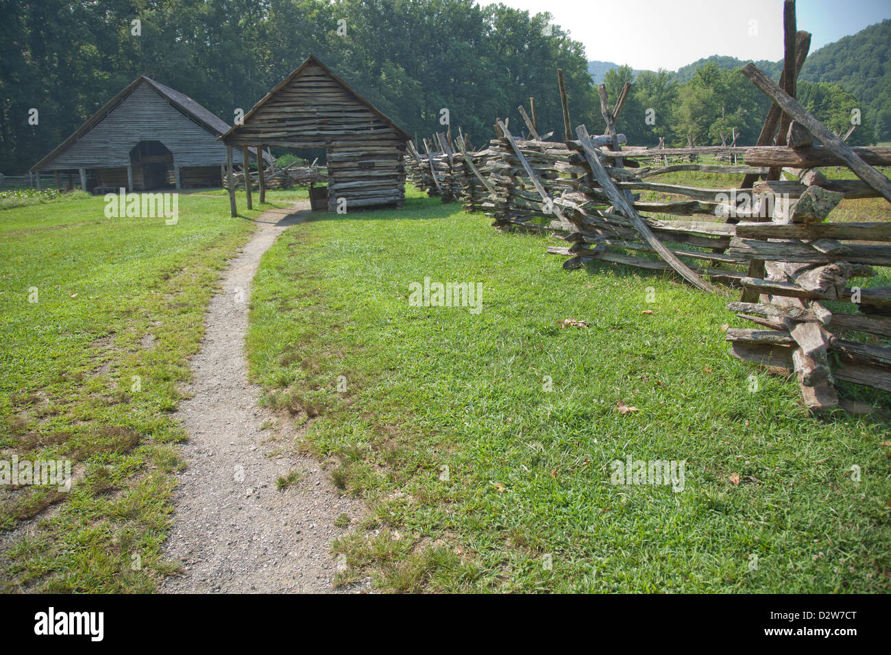 Worn path to the barn, past a split rail fence and a tool building ...