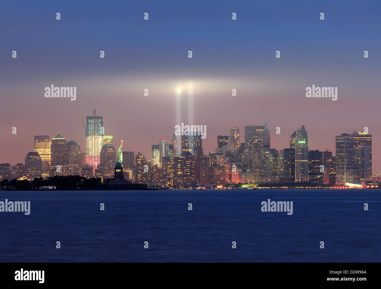 New York City Manhattan downtown skyline panorama at night with statue ...
