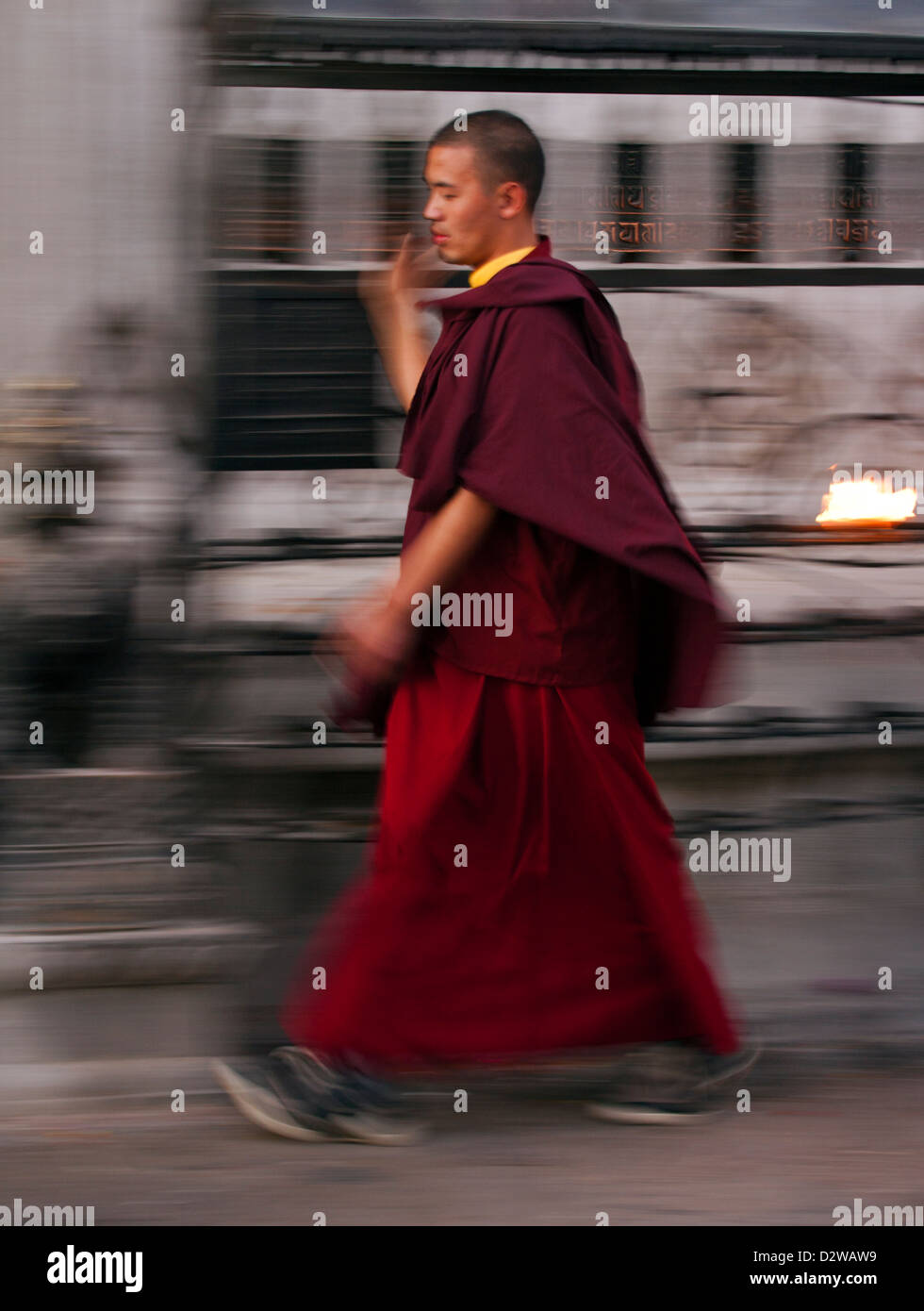 Monk spinning prayer wheels at the Swayambhunath Temple in Kathmandu, Nepal. Stock Photo