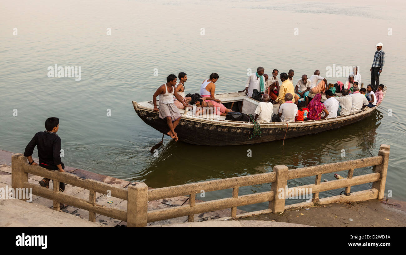 man watching a boat on the river Ganges, Varanasi, India Stock Photo