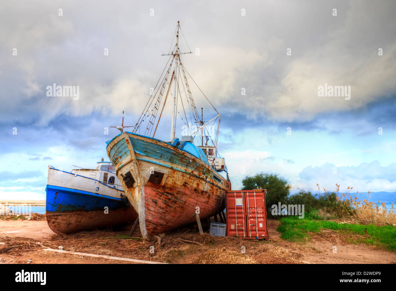 Old ship and shipping container Stock Photo