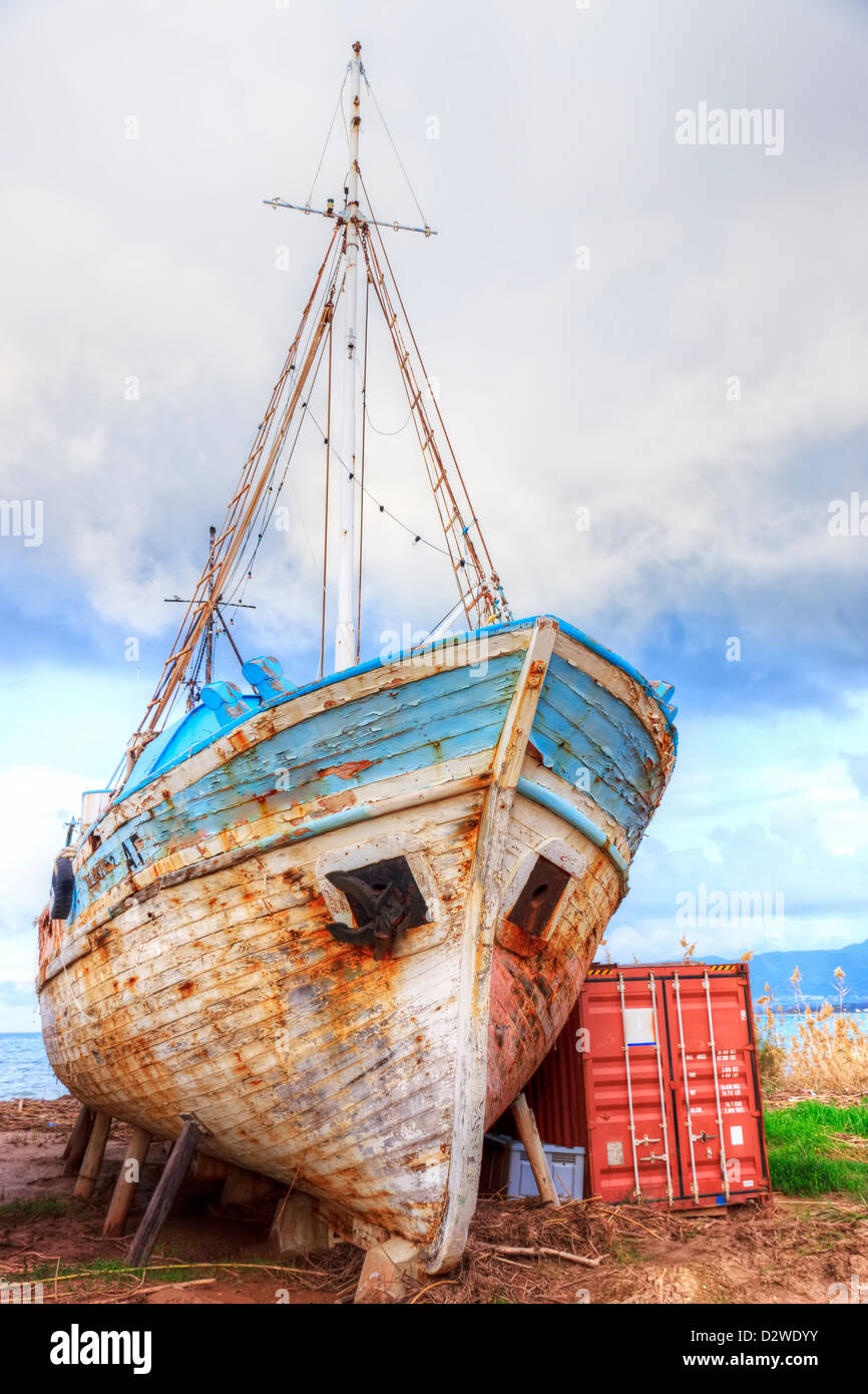 Old ship and shipping container Stock Photo