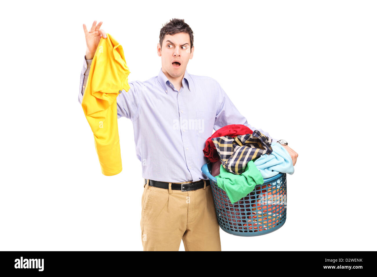 Man holding a smelly blouse and a laundry basket isolated on white background Stock Photo