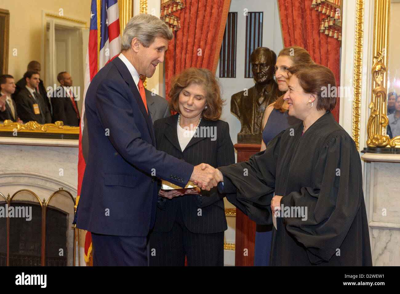 US Supreme Court Justice Elena Kagan congratulates Secretary of State John Kerry following his swears in ceremony in the Foreign Relations Committee Room in the US Capitol February 1, 2013 in Washington, DC. Kerry's wife Teresa, daughter Vanessa, brother Cameron look on during the brief ceremony. Stock Photo