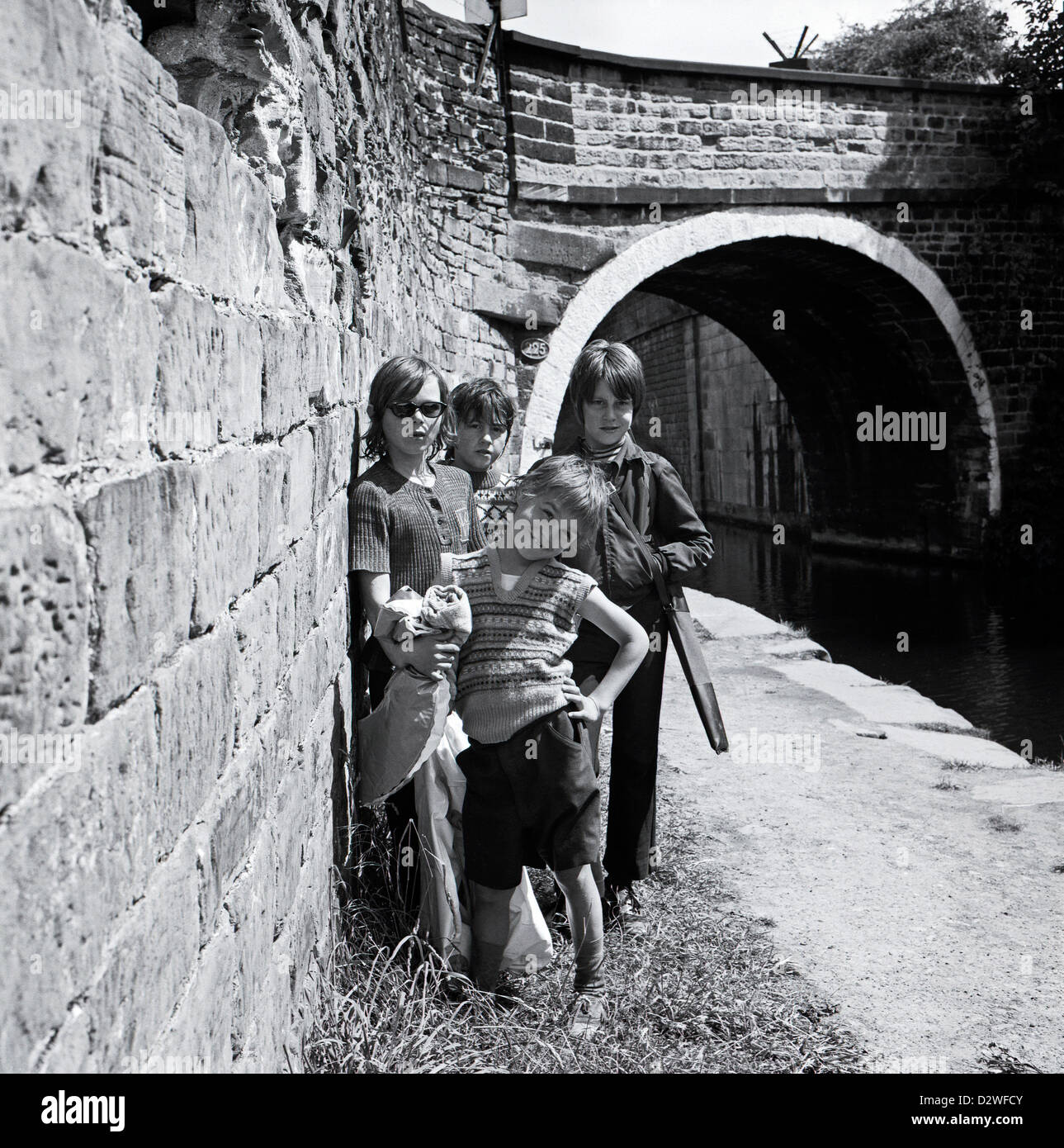 Young boys in summer posing for the camera on the towpath along the Leeds & Liverpool canal West Yorkshire 1974 KATHY DEWITT Stock Photo