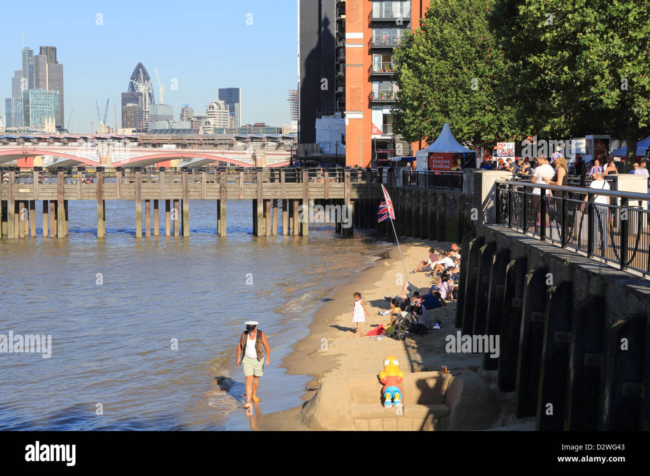 The urban beach at Gabriel's Wharf on the South Bank, with the City and Gherkin behind, London, England, UK Stock Photo