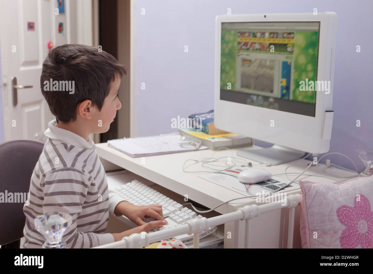 Child plays computer games at home Stock Photo