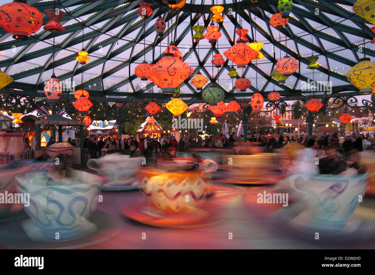 A night time fair ride on the tea cups Disneyland Paris Stock Photo Alamy