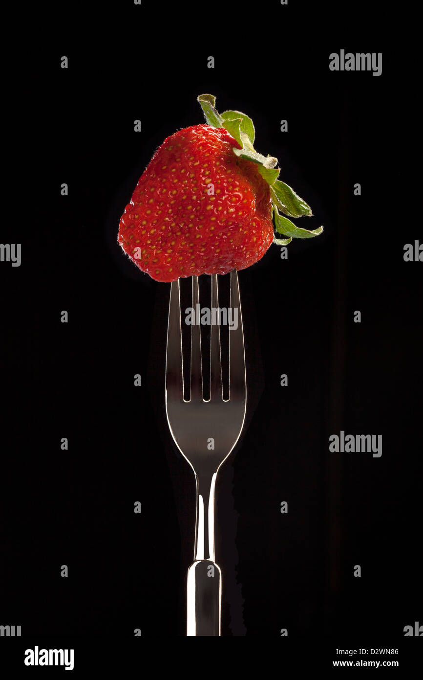 a fresh strawberry on a black background Stock Photo - Alamy