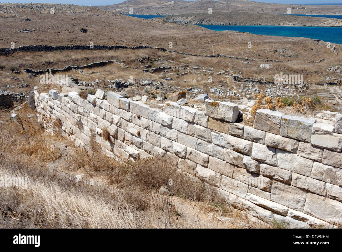 Delos. Greece. The cavea retaining wall of the ancient theatre which dates from the 3rd century BC. Stock Photo