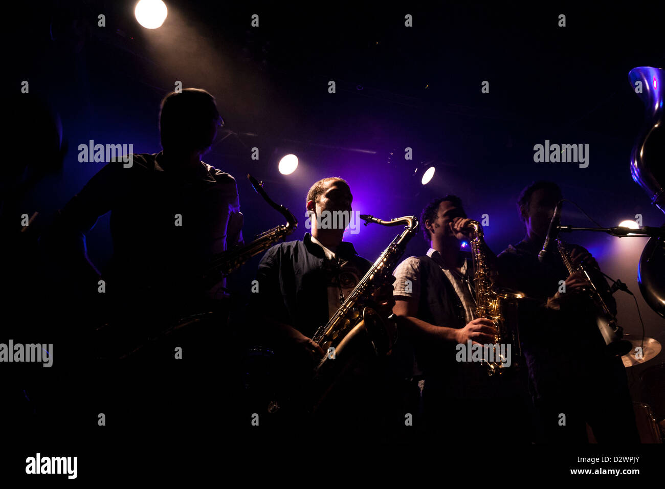 Saxophonists in a concert. High contrast, some are silhouetted. All are from Israeli Brass band 'Marsh Dondurma'. Stock Photo