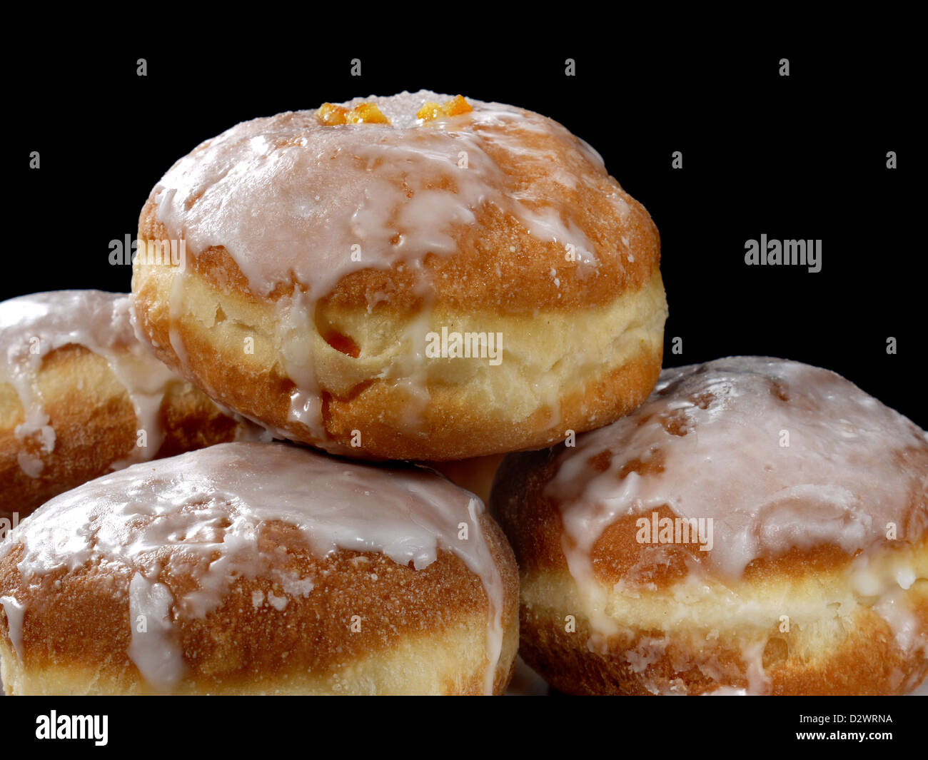 Polish donuts with icing over black background Stock Photo