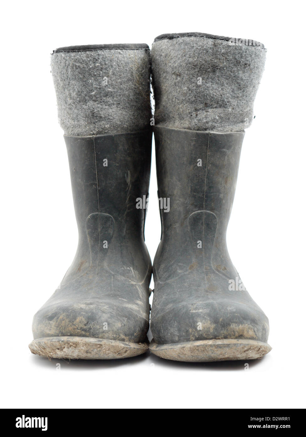 Dirty rubber-soled felt insulated boots shot over white Stock Photo