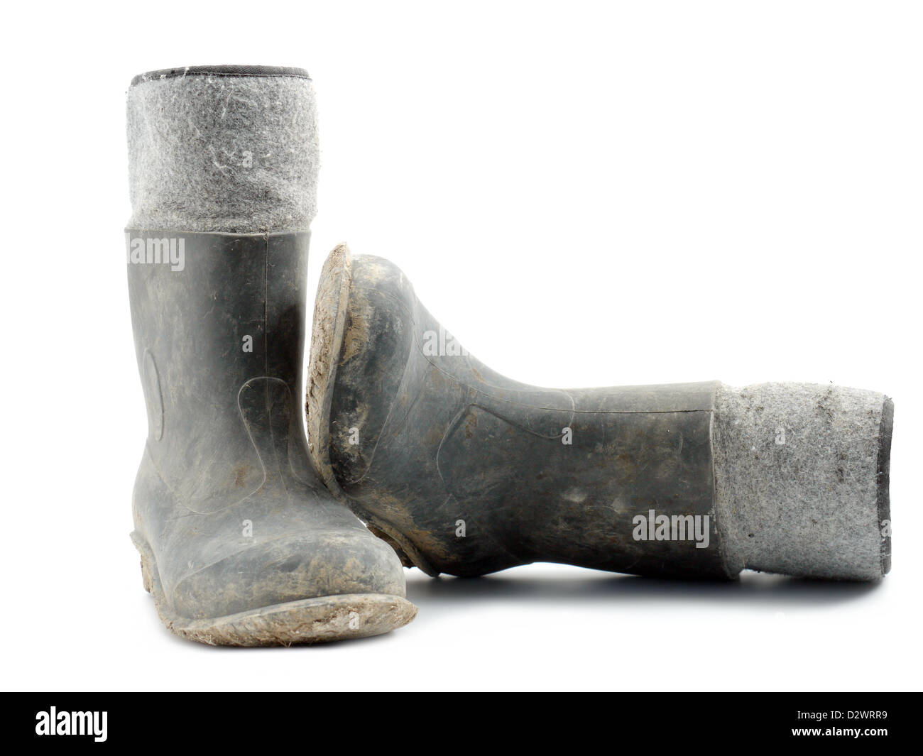 Dirty rubber-soled felt insulated boots shot over white Stock Photo