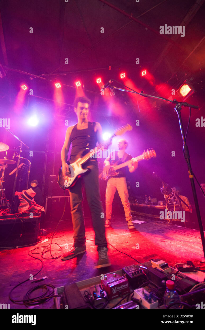 Israel. A rock band performs in a Guitar effect boxes in the foreground. Smoke and