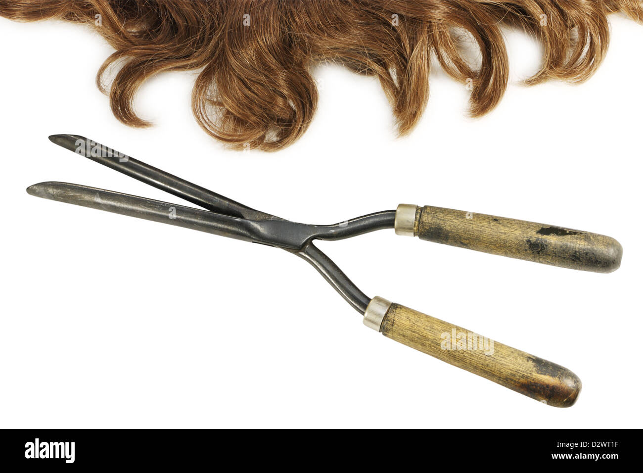 Vintage hot curling tongs and waved hair isolated on white background Stock Photo