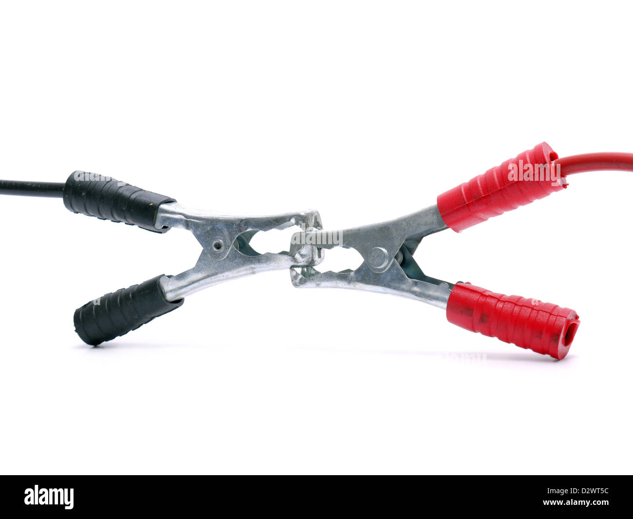 Two jumper cables engaged with their black and red clamp shot over white Stock Photo