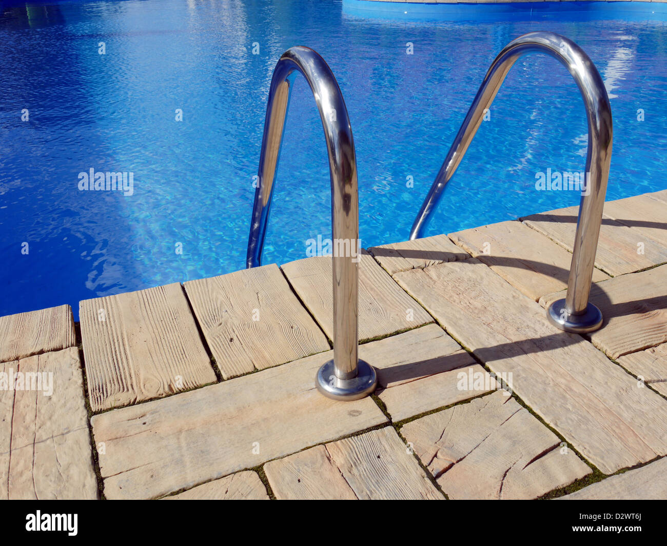 Swimming pool edge with steel handle bars Stock Photo