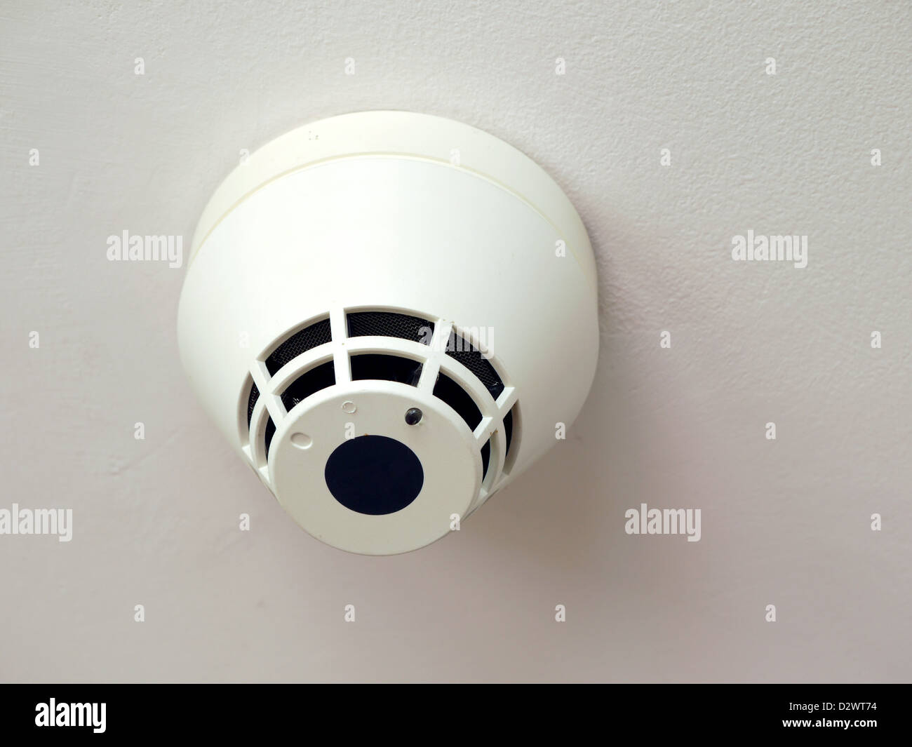 Smoke detector mounted to the ceiling Stock Photo