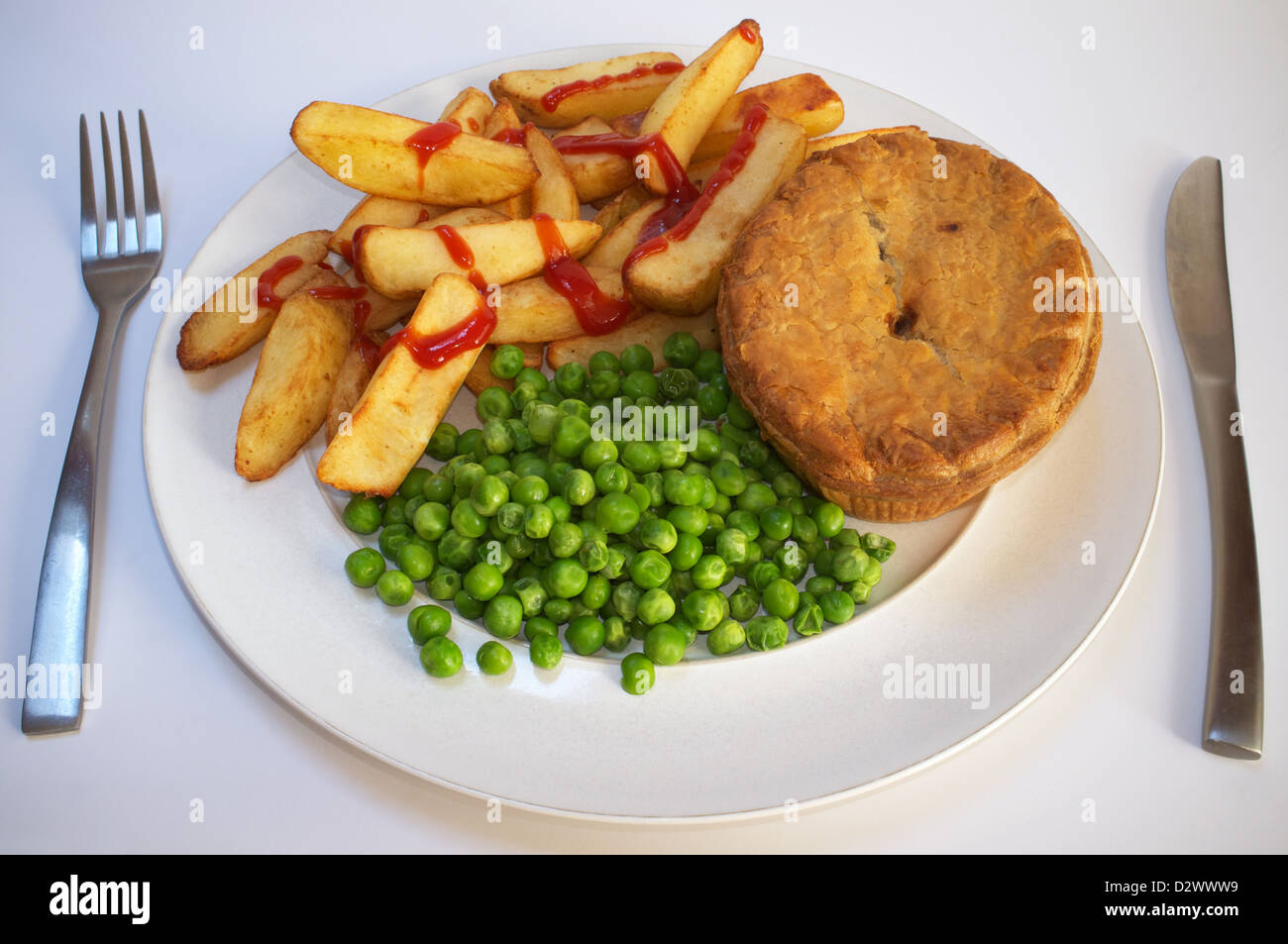 Meat pie with chips & peas Stock Photo