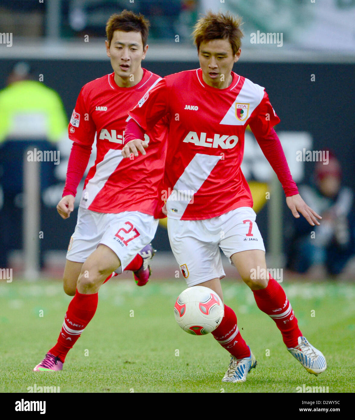 Augsburg's  Ja-Cheol Koo (L) and Dong-Won plays the ball during the Bundesliga soccer match between VfL Wolfsburg and FC Augsburg at Volkswagen Arena in Wolfsburg, Germany, 02 February 2013. Photo: PETER STEFFEN Stock Photo