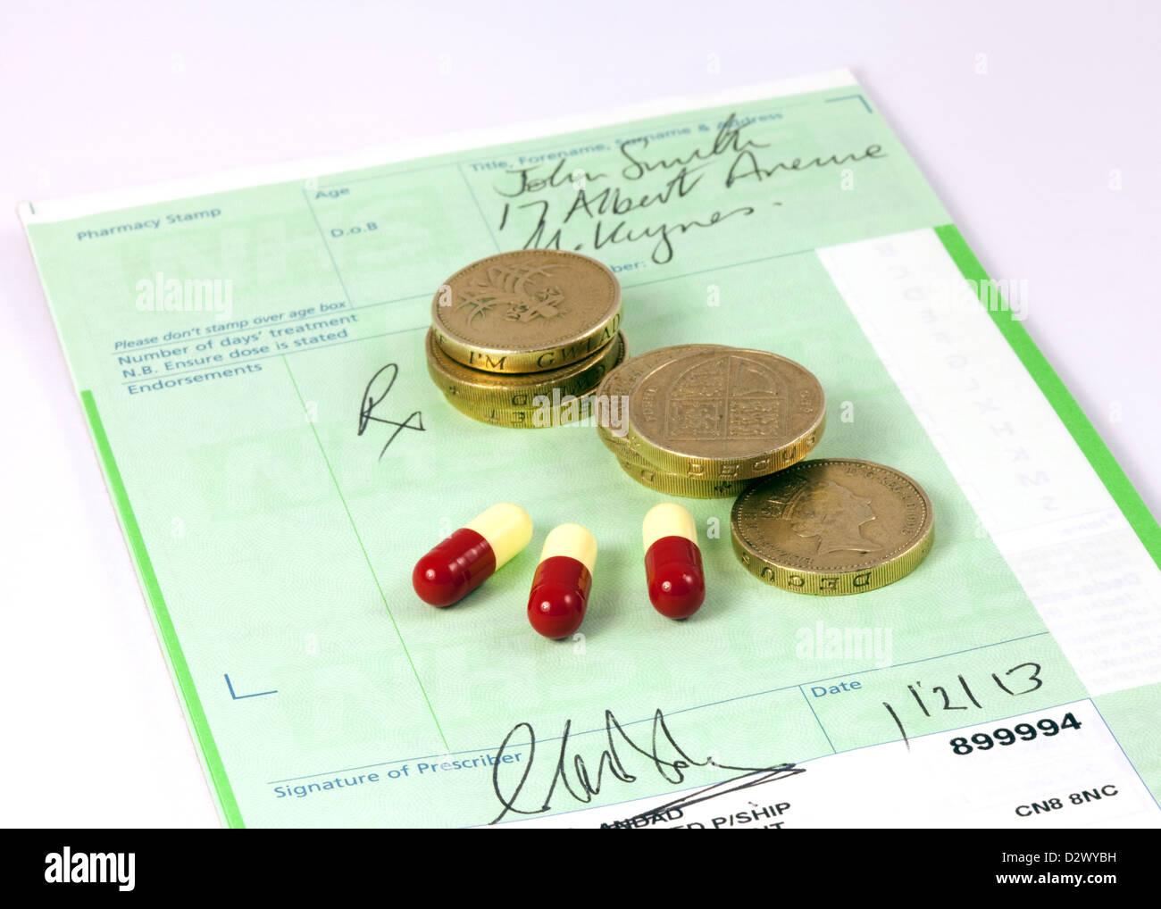 NHS prescription with pound coins and drugs to illustrate the concept of prescription drug costs, UK Stock Photo