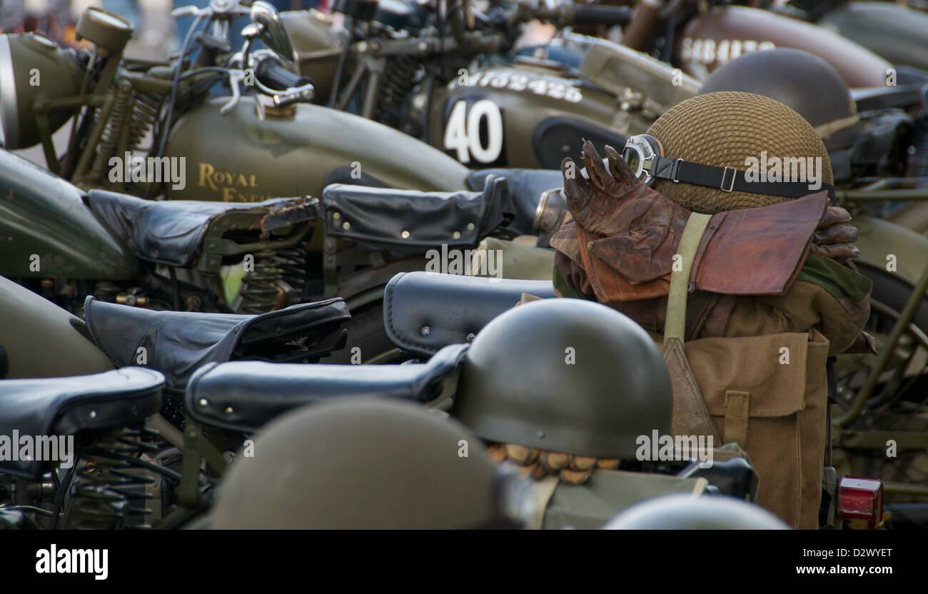 Old Military helmet and leather gloves on military world war 2 royal enfield motorcycle Stock Photo