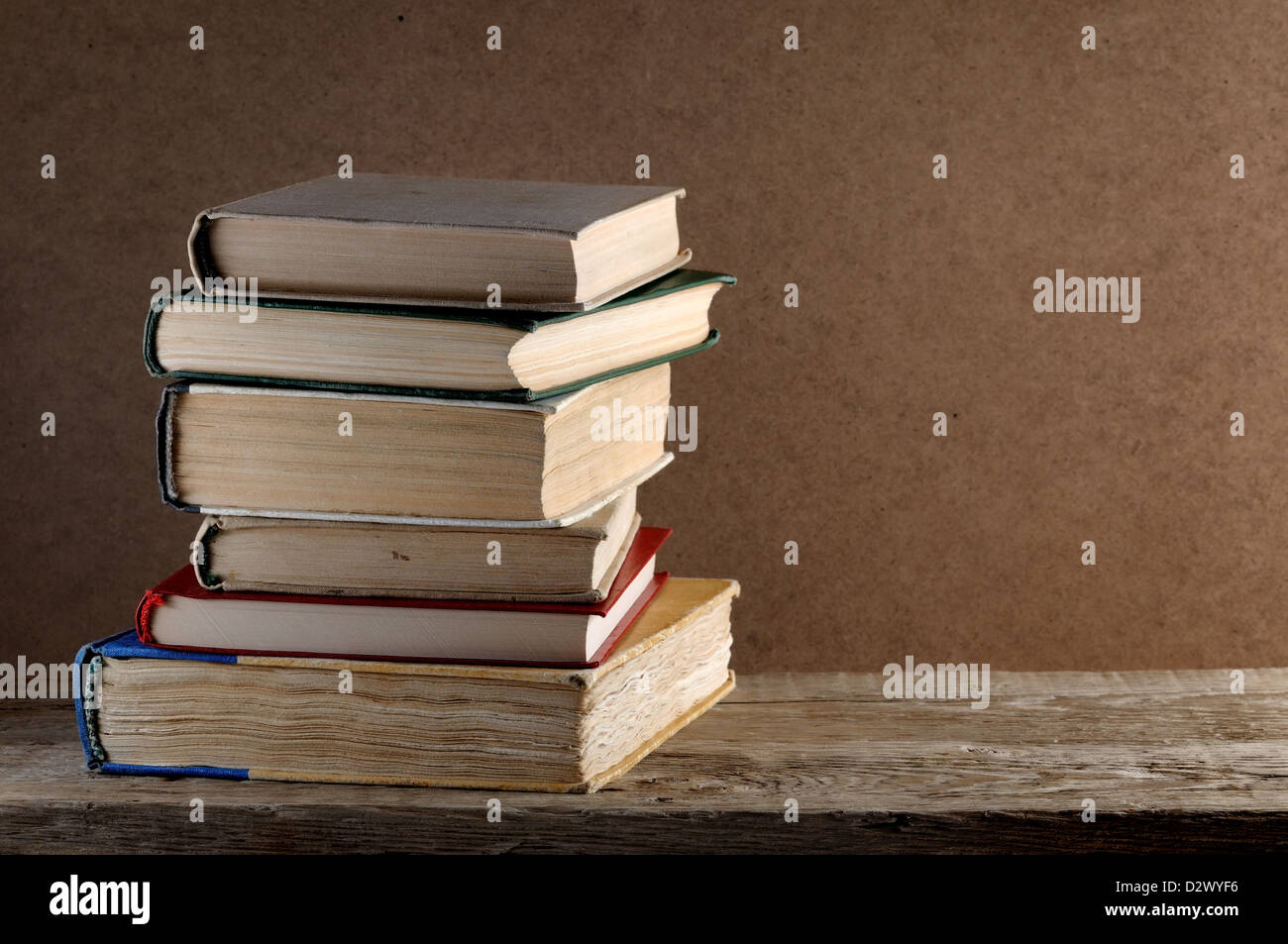 Pile of old books on wooden table Stock Photo - Alamy