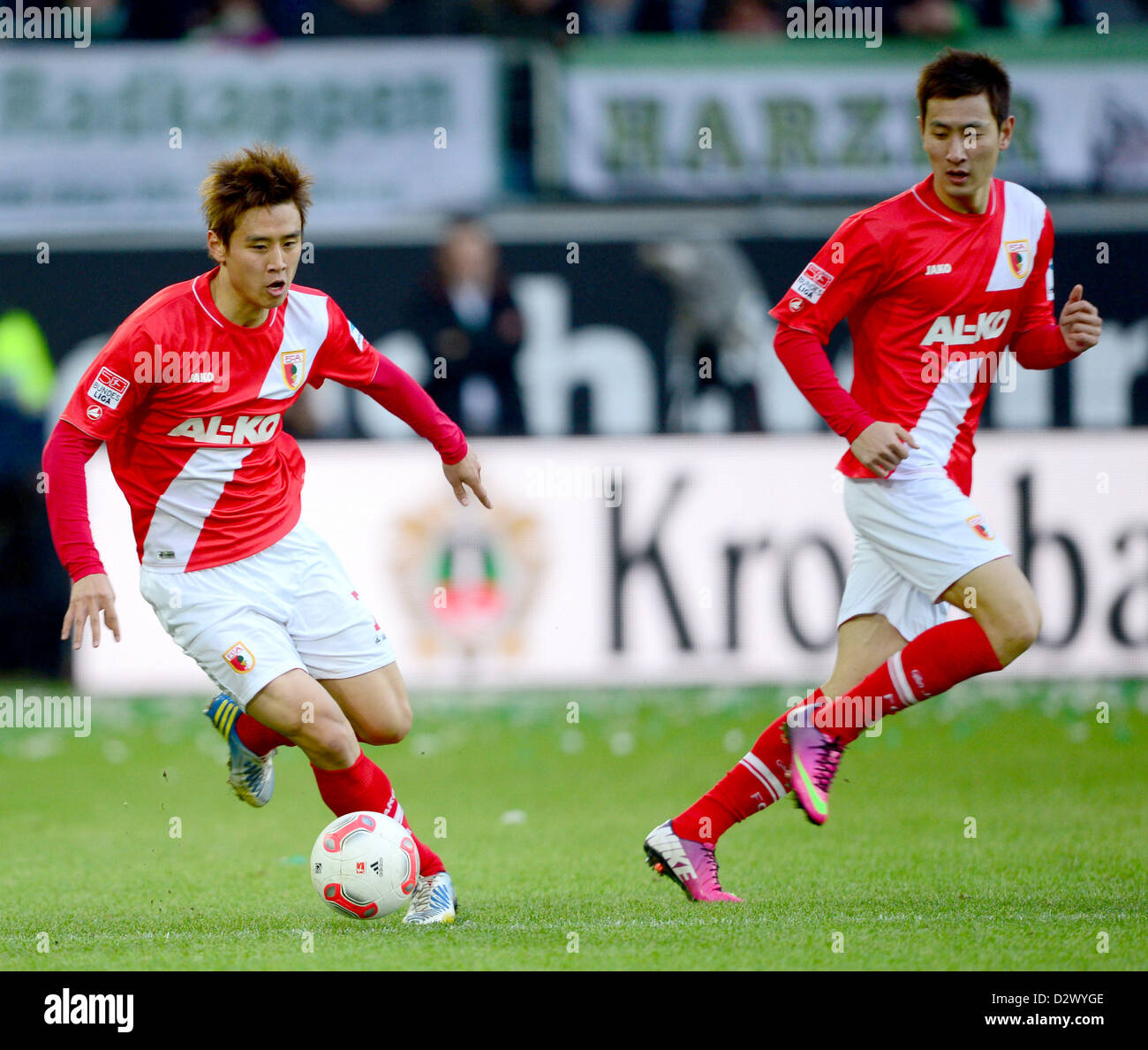 Augsburg's  Ja-Cheol Koo (L) and Dong-Won plays the ball during the Bundesliga soccer match between VfL Wolfsburg and FC Augsburg at Volkswagen Arena in Wolfsburg, Germany, 02 February 2013. Photo: PETER STEFFEN Stock Photo
