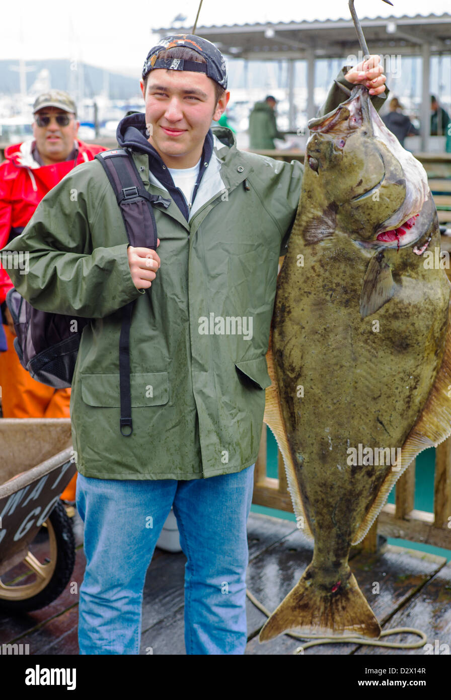 Charter boat fisherman take photographs of themselves with their fresh catch of the day, Seward