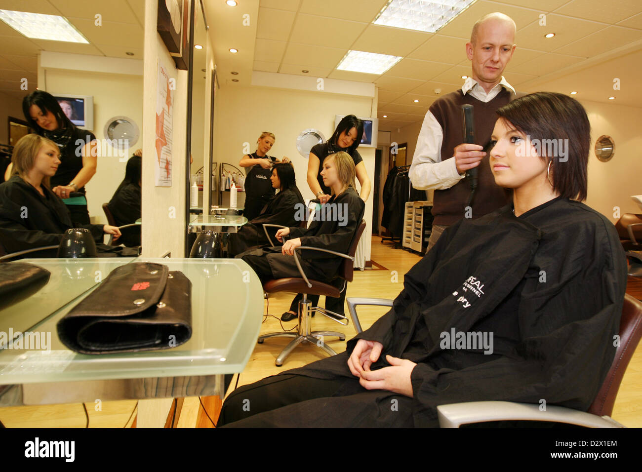 Hairdressers And Stylists At Work In A Modern Beauty Salon Stock