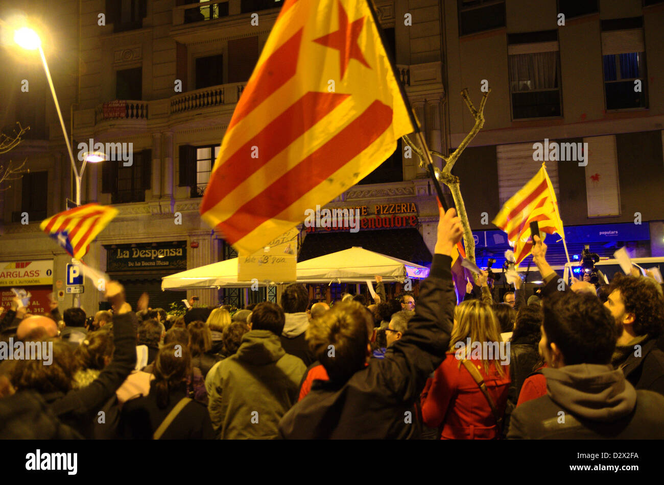 Demonstration of the 'indignados' the night of 2nd Februart against secret bonuses in the spanish governtment and corruption. The demonstration ended in front of the Partido Popular headquarters in Barcelona. People with catalonian independentists flags. Stock Photo