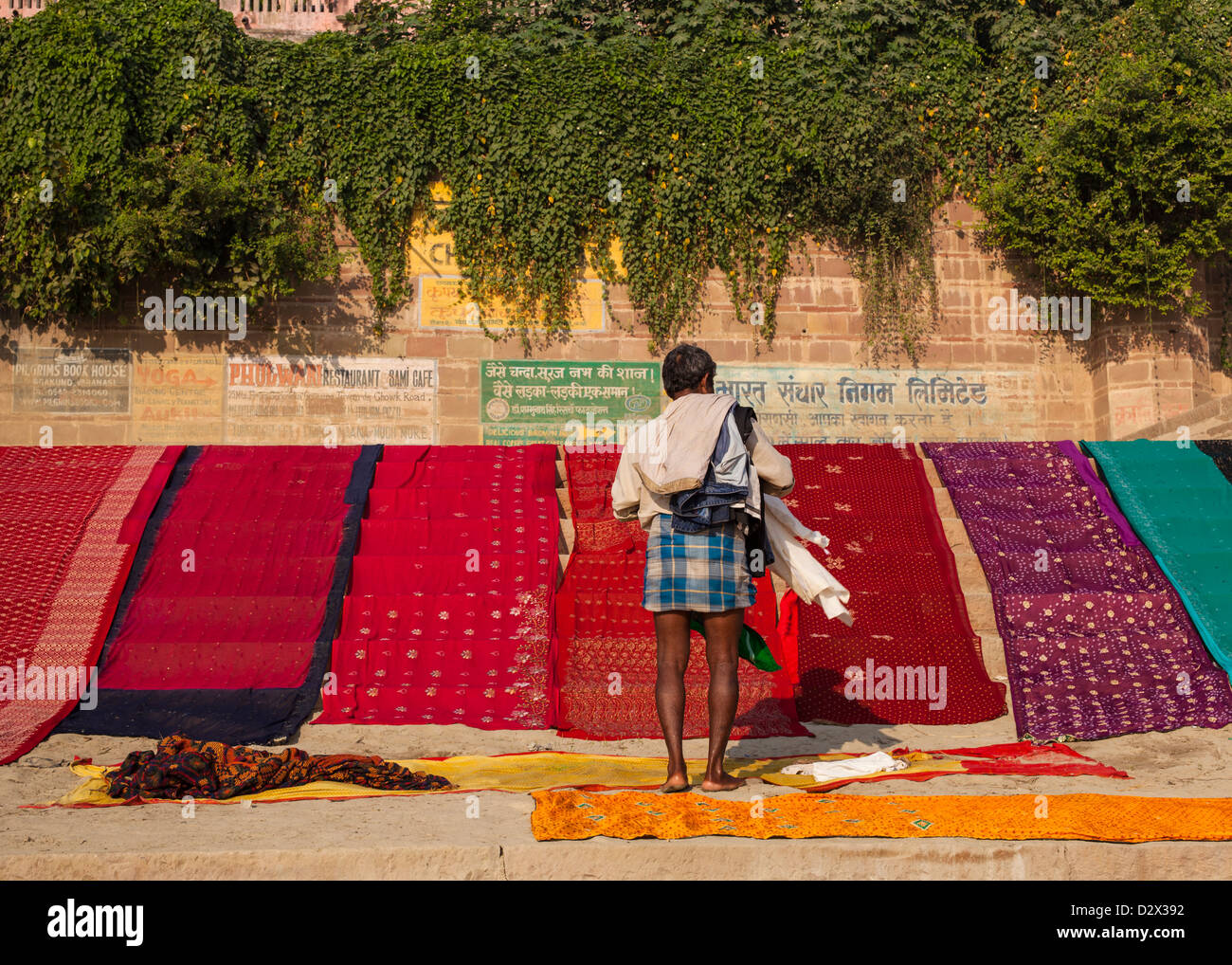 Colourful Saris drying on a ghat, Varanasi, India Stock Photo