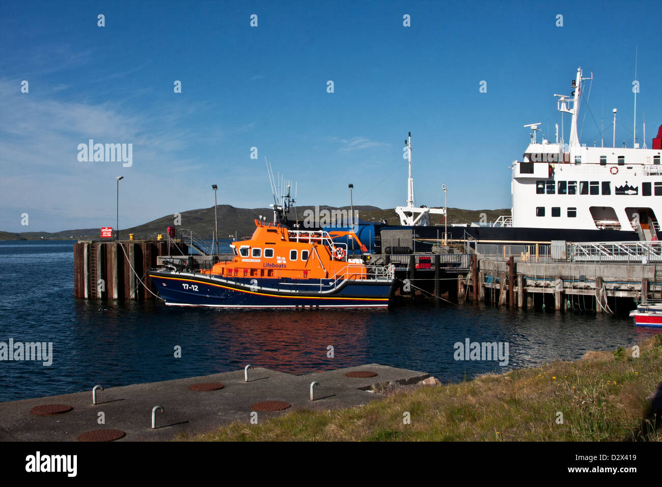 Coast Guard boat RNLB Edna Windsor and cruise liner Hebridean Princess lie at dock in Castlebay, Isle of Barra, Scotland Stock Photo