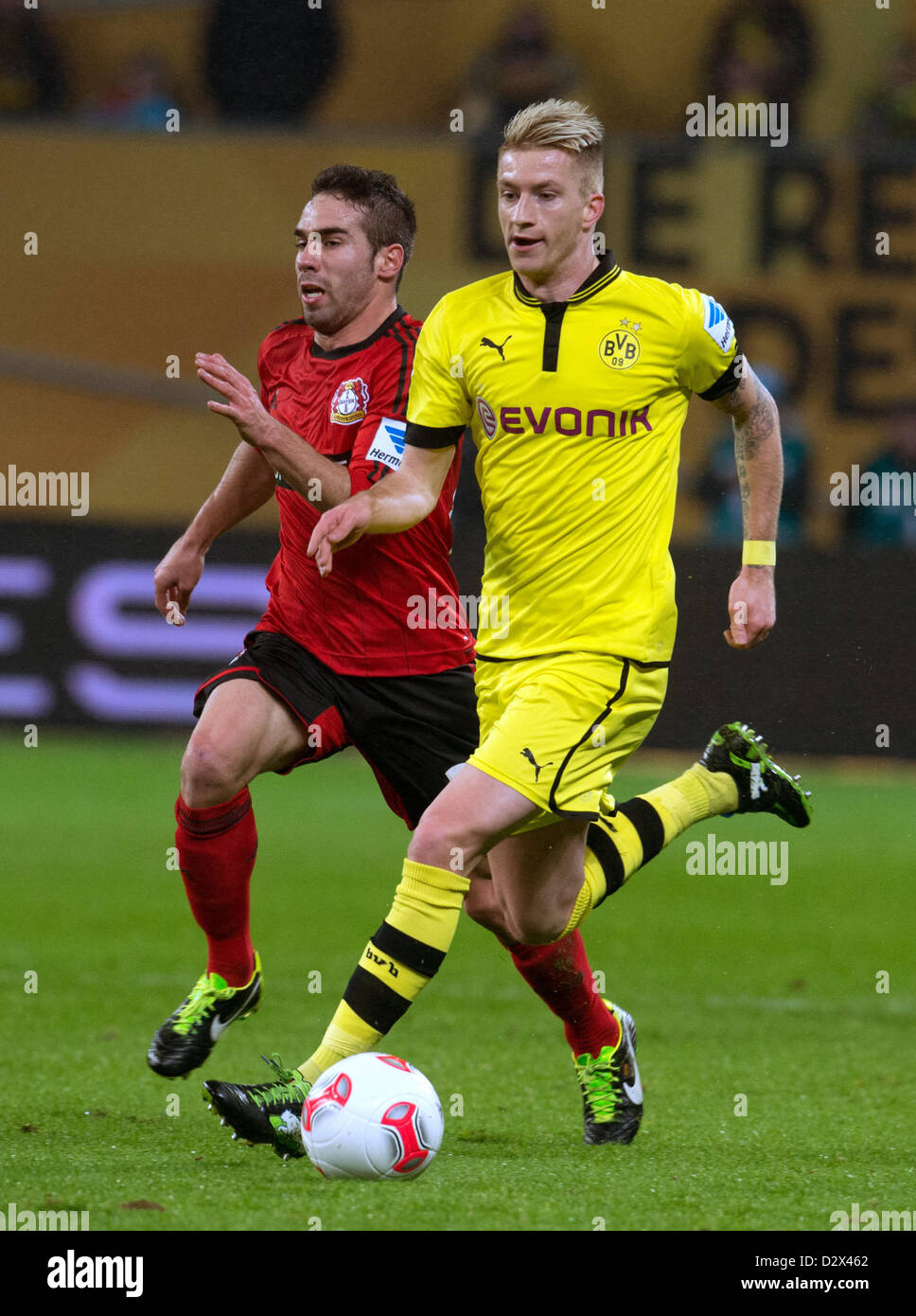 Dortmund's Marco Reus (R) vies for the ball with Leverkusen's Daniel Carvajal (L) during the German Bundesliga soccer match between Bayer Leverkusen and Borussia Dortmund at BayArena in Leverkusen, Germany, 03 February 2013. Photo: BERND THISSEN (ATTENTION: EMBARGO CONDITIONS! The DFL permits the further utilisation of up to 15 pictures only (no sequential pictures or video-similar series of pictures allowed) via the internet and online media during the match (including halftime), taken from inside the stadium and/or prior to the start of the match. The DFL permits the unrestricted transmissio Stock Photo