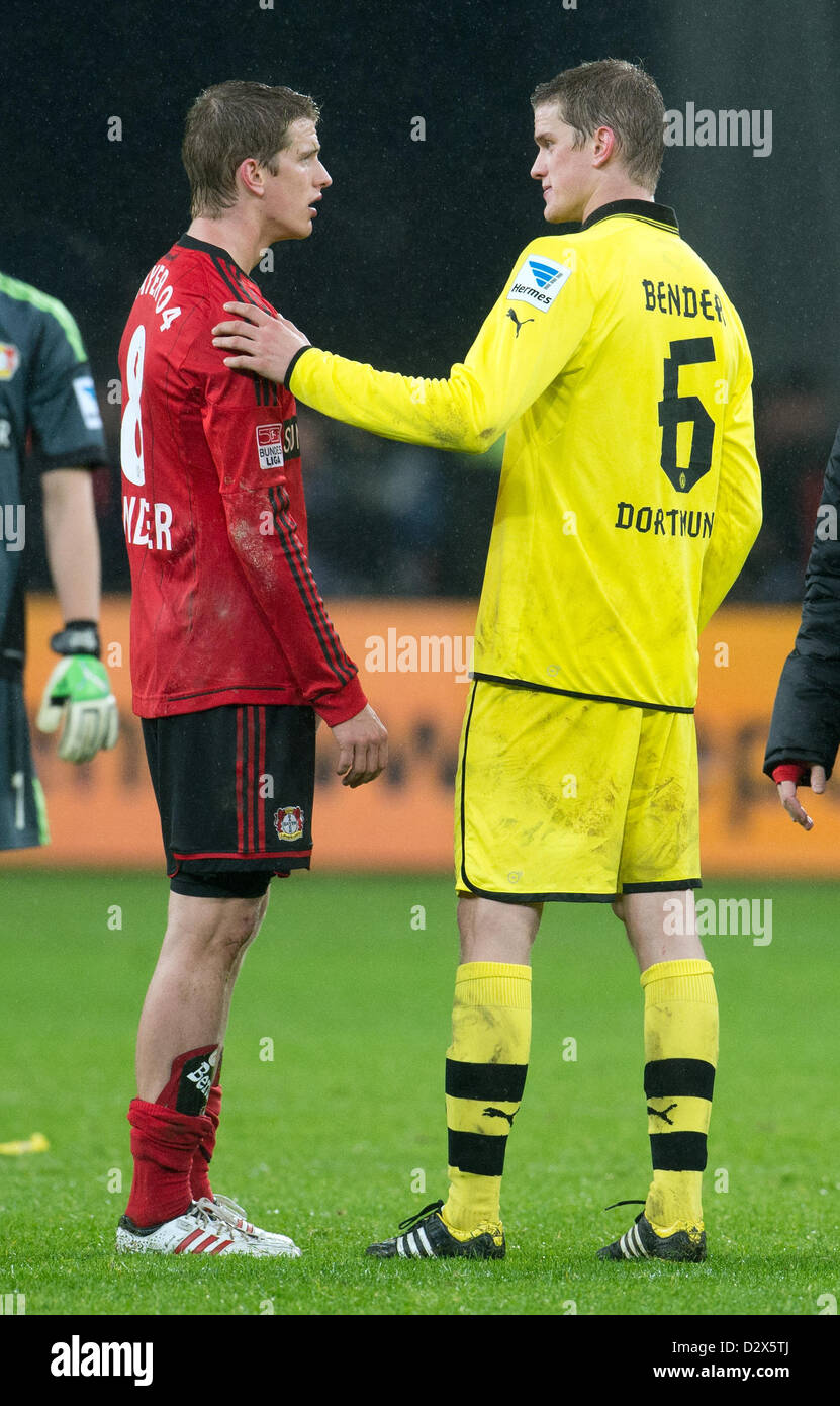 Dortmund's  Sven Bender (R) and his twin Leverkusen's Lars Bender chat after the German Bundesliga soccer match between Bayer Leverkusen and Borussia Dortmund at BayArena in Leverkusen, Germany, 03 February 2013. Photo: BERND THISSEN (ATTENTION: EMBARGO CONDITIONS! The DFL permits the further utilisation of up to 15 pictures only (no sequential pictures or video-similar series of pictures allowed) via the internet and online media during the match (including halftime), taken from inside the stadium and/or prior to the start of the match. The DFL permits the unrestricted transmission of digitis Stock Photo