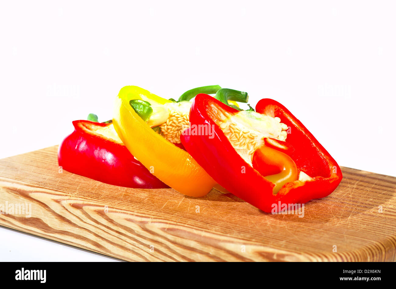 Slices of red and yellow paprika on white background Stock Photo