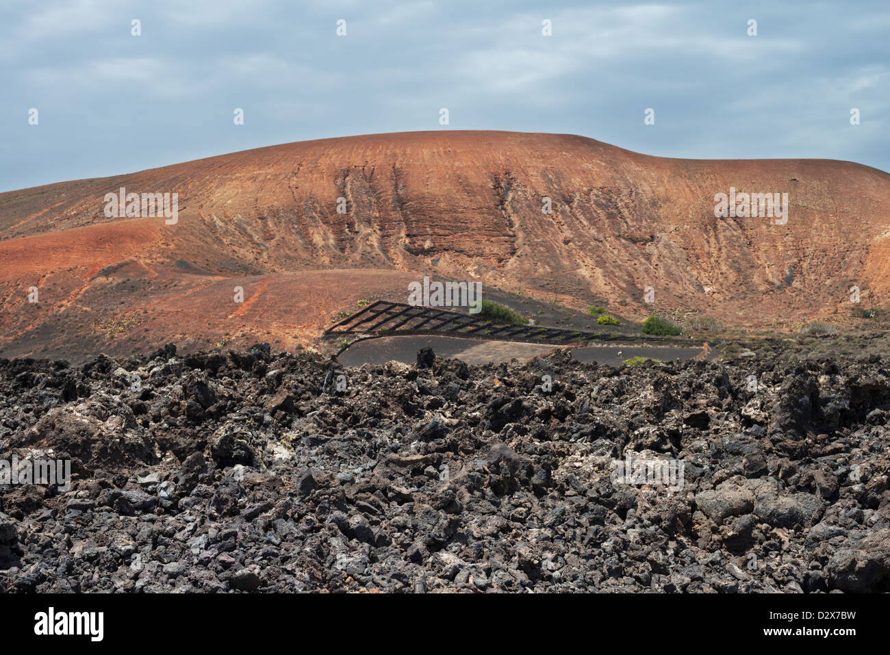 View towards Montana de los Rostros across the aa lava flows of the 1730-1736 eruption on Lanzarote, Canary Islands, Spain Stock Photo